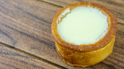 Japanese cheese baked tart on wooden background.