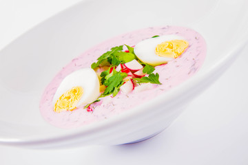 Cold borscht (chlodnik) - traditional Lithuanian cold soup with radish, parsley, dill and egg