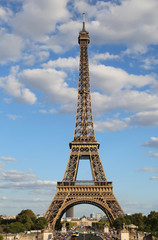 Fototapeta na wymiar High Eiffel Tower Symbol of Paris in France with some clouds in