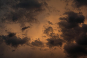 Cloudy evening sky lit by the setting sun