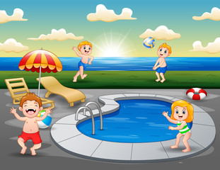 Children playing in outdoor swimming pool on the beach