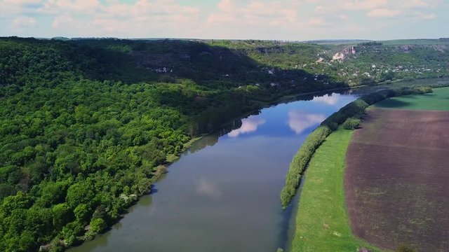 Flight over the river and forest at spring time. Dniester river of Moldova republic.