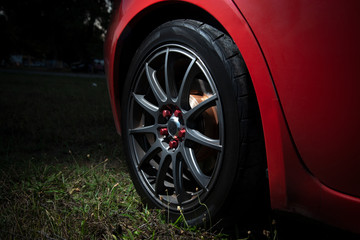 car wheel with alloy wheel gray color on red car
