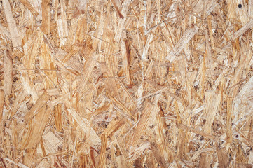 Plywood surface, texture, wooden background and wall. A fragment of amber-colored fiberboard....