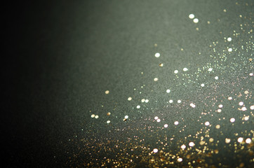 Golden sparkles on black background. Festive concept. - Image