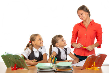 Girls at their desks have fun watching their beloved teacher