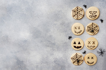 Homemade cookies for Halloween. Cookies with funny faces and spider webs. Copy space.