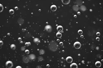 Bubbles of oxygen or air in a dark liquid. For projects with liquid or oil. Macro