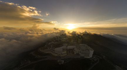 Malaysia Genting Highland with sunset and dramatic cloud city above the cloud. noise are existed in a drone photography