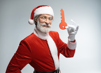 Fototapeta na wymiar Santa Claus with paper key in hand