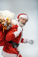 Santa Claus walking with sack full of presents