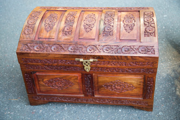 The chest is wooden with decorative painting. Folk art.