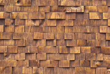 Texture of a wall of wooden bars. Stone bricks are made in the form of wooden boards.