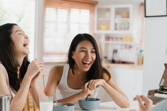 Asian Women Have Breakfast At Home, Group Of Young Asia Friend Girls Feeling Happy Fun Talking Together While Have Breakfast In Kitchen In The Morning Concept.