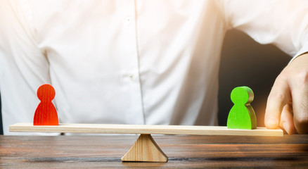 A person changes the balance of scales in favor of a green person figure. Mediator services....