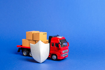 Red truck with a load of boxes behind the shield. Cargo insurance, transportation safety....