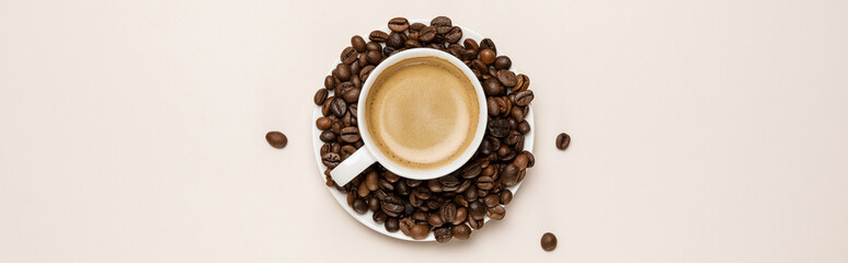 top view of coffee cup on saucer with grains on beige background, panoramic shot