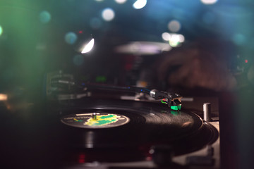 Vinyl record in the dance club with disc jockey