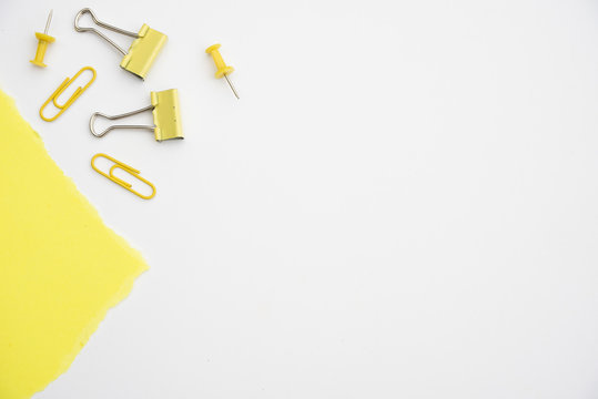 Yellow Paperclip And Pushpin On White Background With Copy Space