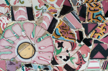 texture mosaic of colored ceramic tile by Antoni Gaudi at his Parc Guell, Barcelona, Spain.