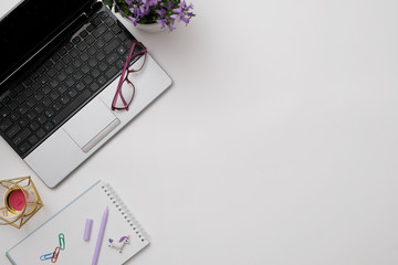 Flat lay modern workspace desk with laptop, glasses, smartphone, coffee cup. Business lady blog hero concept.