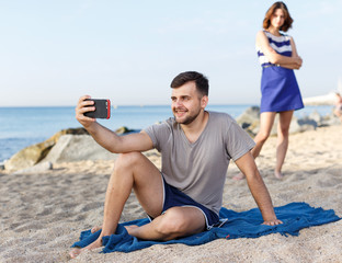 Young man  resting and taking selfie