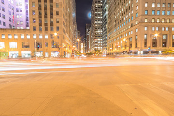 Wacker Dr street with tall buildings and street light trails in Chicago at night