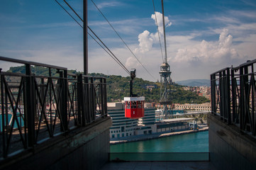 BARCELONA, SPAIN - SEPTEMBER 9, 2014: Overhead cable car from la Barceloneta to the Montjuic hill. Barcelona, Catalonia, Spain. Cabin full of passengers is departing to the station of Montjuic