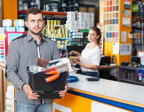 Man with purchases in household store