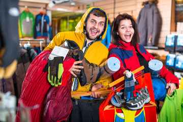 Young couple demonstrating tourist equipment