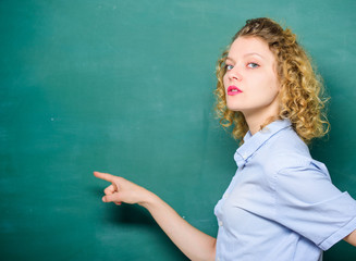 Look at this. knowledge day. empty blackboard information. education. Students life. woman teacher at school lesson. back to school. woman likes studying. student pointing at blackboard. copy space