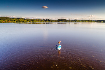 Germany, Bavaria, Allgaeu, standup paddler at the Frankenhofner lake at sunset