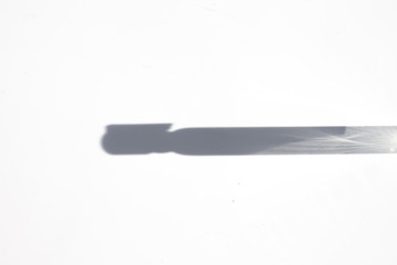  Shadow from the sampler of perfume on a white background.