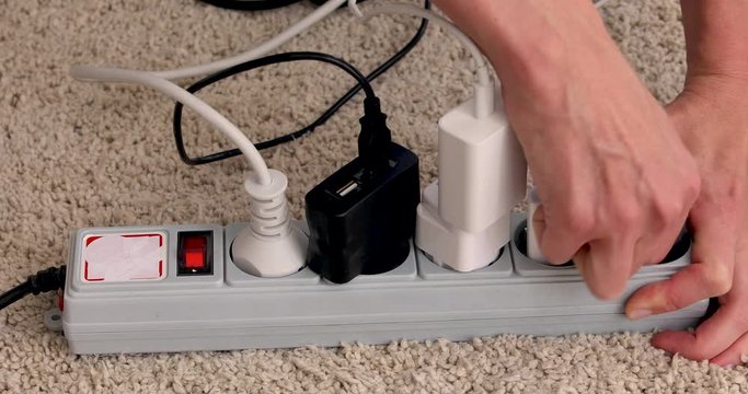 girl hands turn off and unplug wires from electricity switch at home. Energy saving concept