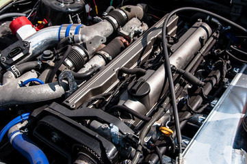 Obraz na płótnie Canvas sports car engine, check the motor before the trip. under the hood. extreme sport