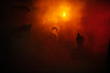 Obraz na płótnie Canvas Fans of serbian soccer team FC Red Star lit torches ofter team scored a goal