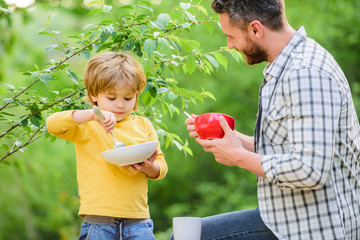 Father teach son eat natural food. Little boy and dad eat. Nutrition kids and adults. Organic nutrition. Healthy nutrition concept. Nutrition habits. Family enjoy homemade meal. Personal example