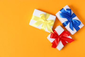 gifts on a colored background top view. Holiday, giving presents, birthday.