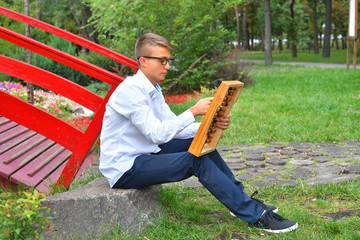 Boy with large abacus. Thoughtful schoolboy using a maths abacus calculation
