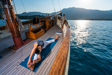 Man practicing Yoga on a sailing yacht