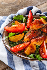 Fried chicken nuggets, baked potatoes and vegetable salad
