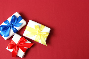 gifts on a colored background top view. Holiday, giving presents, birthday.