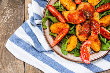 Fried chicken nuggets, baked potatoes and vegetable salad