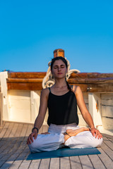 Fototapeta na wymiar Woman practicing Yoga on a sailing yacht