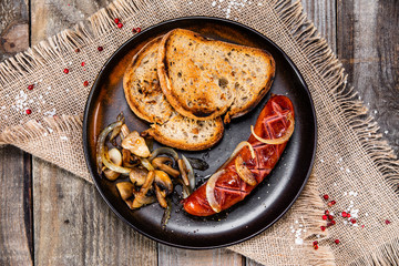 Grilled sausage, toasts and mushrooms