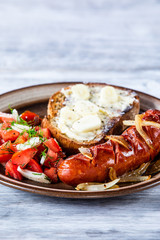 Grilled sausage, toast and vegetable salad