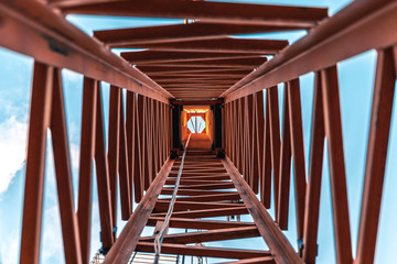 looking up inside a construction crane from the ground.