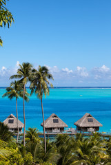 French Polynesia. Over water bungalows and palm trees.. - 284106979