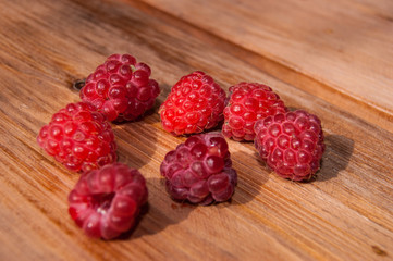 Fresh raspberries on a wooden table close-up