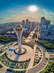 NUR-SULTAN, KAZAKHSTAN (QAZAQSTAN) - August 11, 2019: Beautiful panoramic aerial drone view to Nursultan (Astana) city center with skyscrapers and Baiterek Tower - symbol of Kazakh people freedom - obrazy, fototapety, plakaty